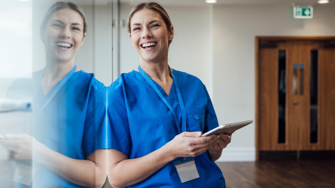 healthcare professional leaning against a window