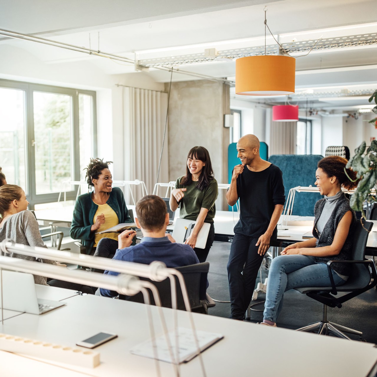 Happy multi-ethnic people discussing in meeting at creative office