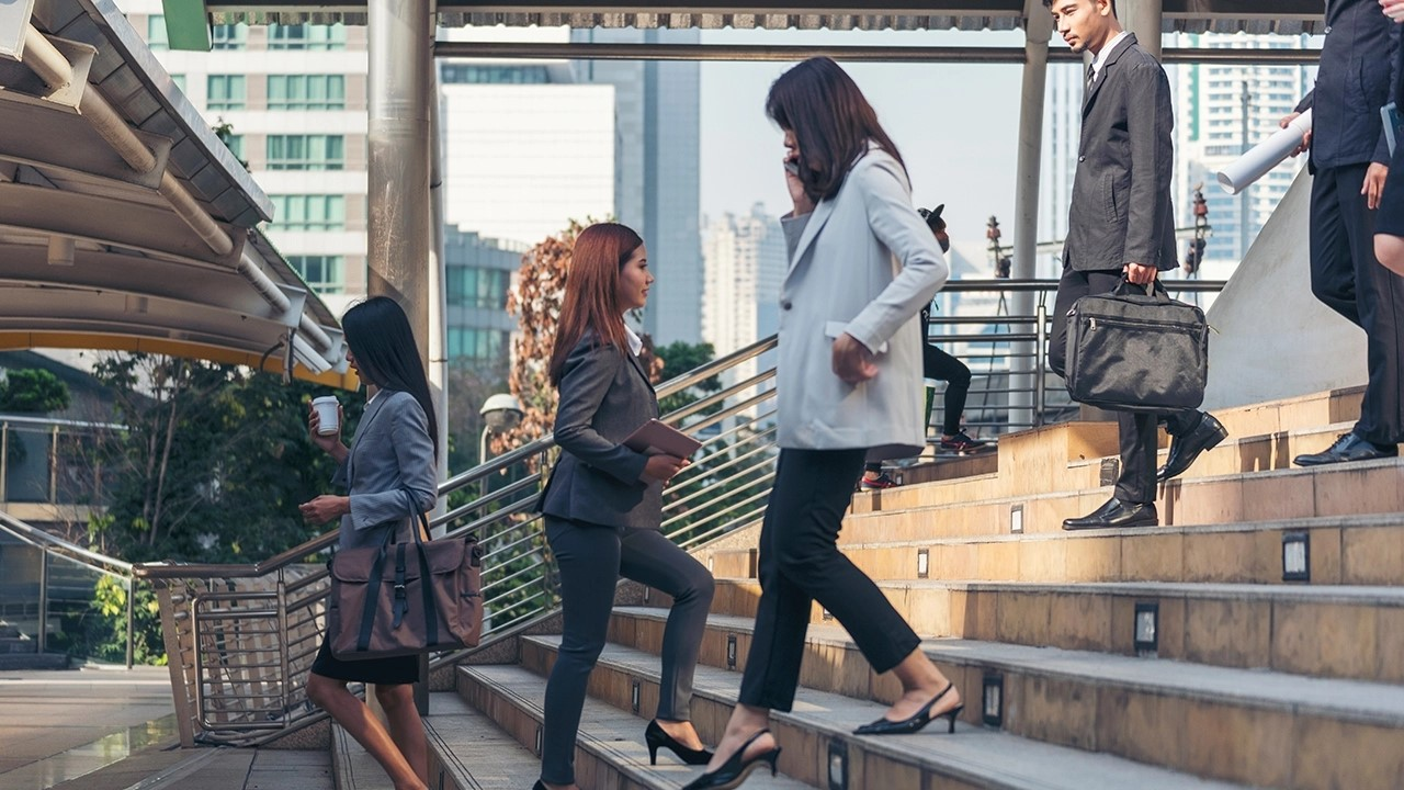 businesspeople climbing stairs to office